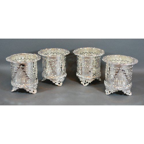 237 - A Set of Four Silver Plated Bottle Stands of pieced embossed form upon shaped feet 12cm tall