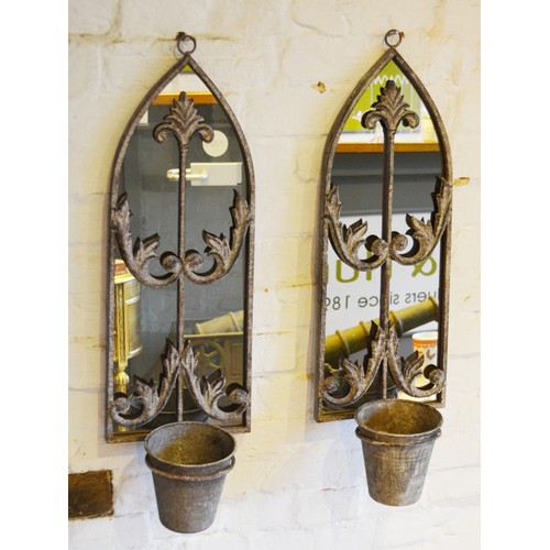 531 - A Pair of Weathered Metal Wall Mirrors of shaped form each with a single planter 64cm by 20cm