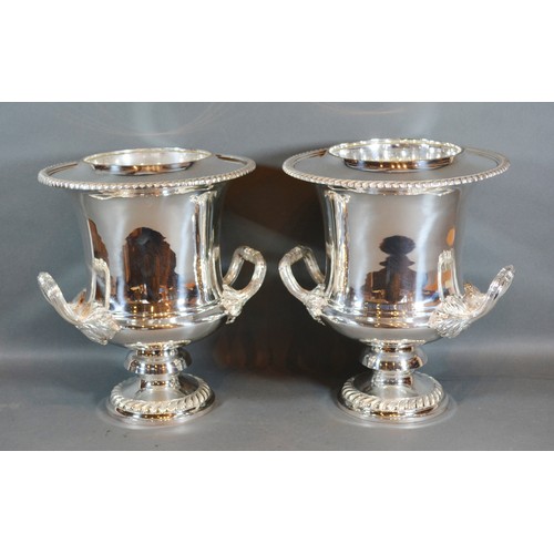 242 - A Pair of Silver Plated Two Handled Wine Coolers with inner liners upon circular pedestal bases 27cm... 