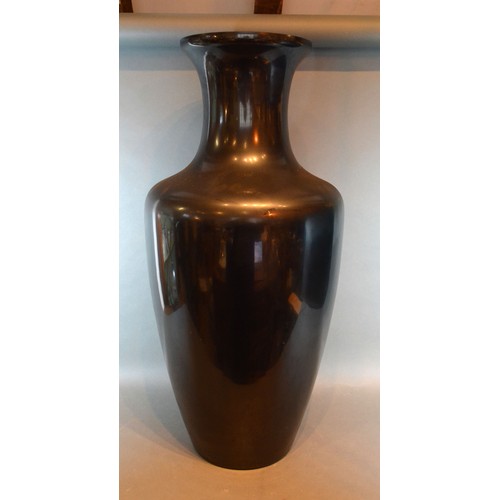 66 - A Black Glass Floor Vase of Oviform 77 cms tall