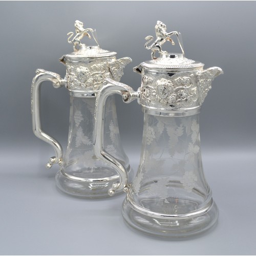 247 - A Pair of Cut Glass and Silver Plated Claret Jugs each with a hinged cover and lion cresting and wit... 