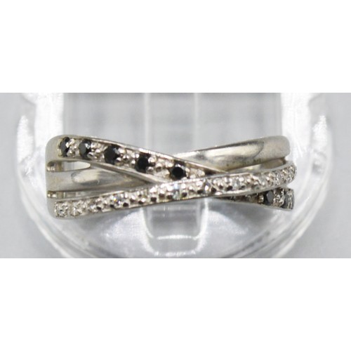 260 - A 14ct White Gold Diamond and Sapphire Crossover Band Ring, 2.8 grams, ring size L