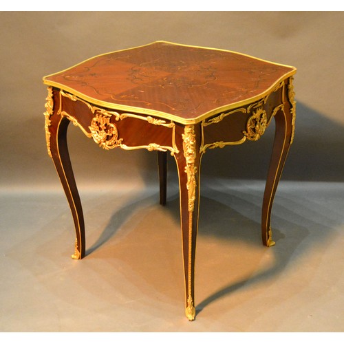 535 - A French Marquetry Inlaid and Gilt Metal Mounted Centre Table with a shaped frieze raised upon cabri... 