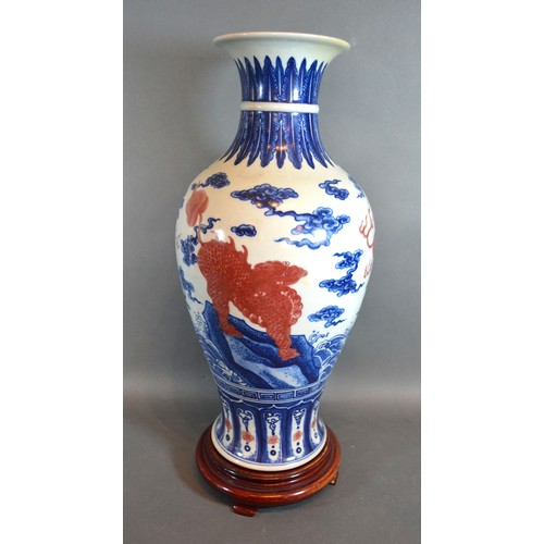 83 - A Chinese Porcelain Oviform Vase decorated with iron red Fu dogs with underglaze blue six character ... 