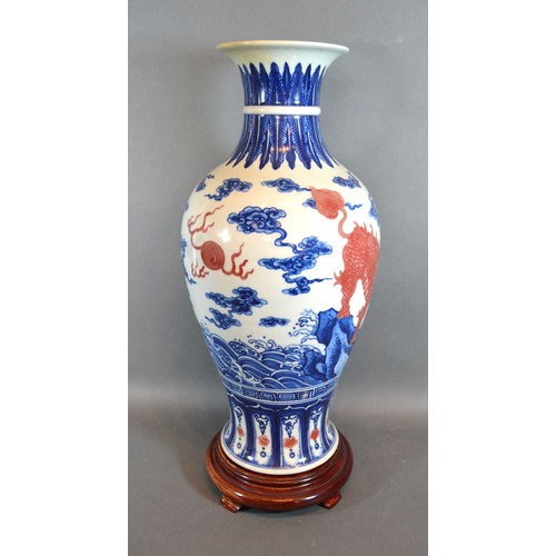 83 - A Chinese Porcelain Oviform Vase decorated with iron red Fu dogs with underglaze blue six character ... 