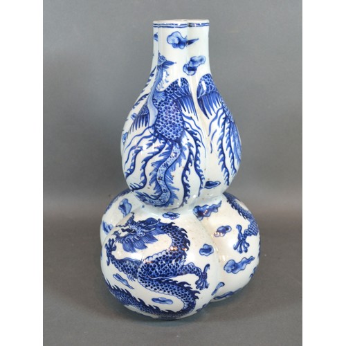 84 - A 19th Century Chinese Porcelain Gourd Vase of Triform decorated in underglaze blue with serpents, b... 