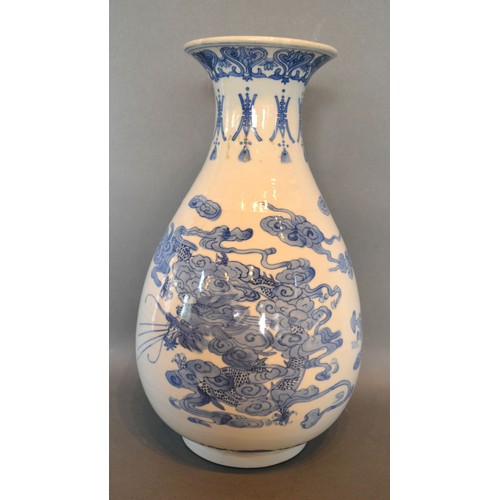 85 - A 19th Century Chinese Porcelain Vase of Oviform decorated in underglaze blue with serpents and fish... 