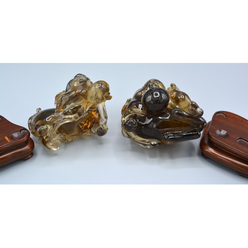 395 - A Pair of Early 20th Century Chinese Rock Crystal Models in the form of Foe Dogs, each with a hardwo... 