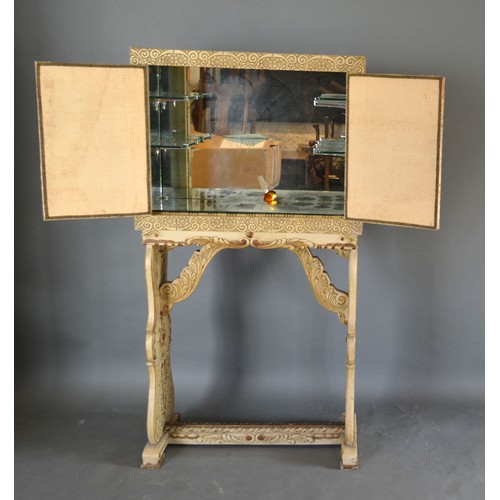 540 - An Art Deco Drinks Cabinet made in the Chinese Style with two fabric doors enclosing a mirrored inte... 