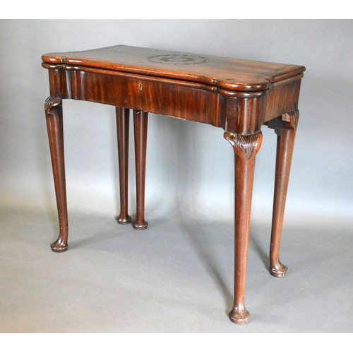 543 - A George III Mahogany Card Table, the shaped hinged top above a plain frieze, raised upon turned tap... 