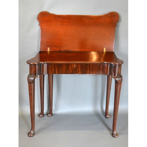 543 - A George III Mahogany Card Table, the shaped hinged top above a plain frieze, raised upon turned tap... 