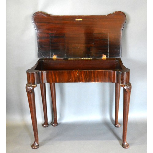 543 - A George III Mahogany Card Table, the shaped hinged top above a plain frieze, raised upon turned tap... 