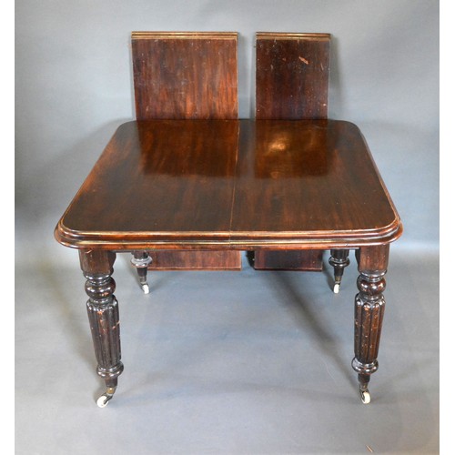 544 - A Victorian Mahogany Wind-Out Extending Dining Table, the moulded top above four reeded tapering leg... 