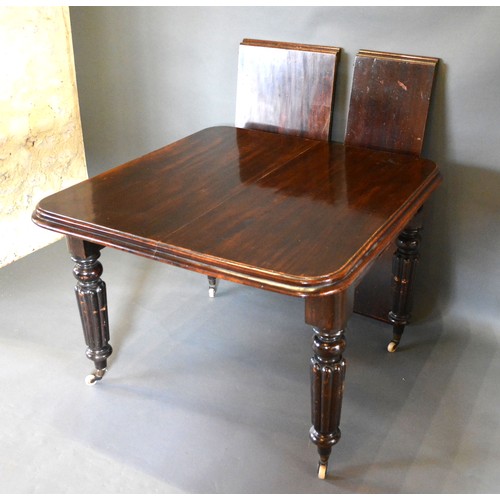 544 - A Victorian Mahogany Wind-Out Extending Dining Table, the moulded top above four reeded tapering leg... 