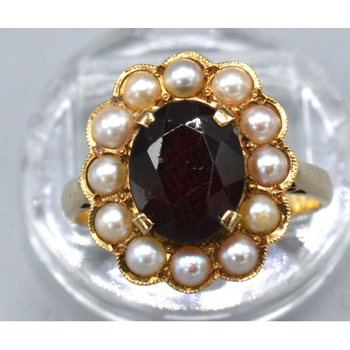 195 - A 9ct. Gold Garnet and Pearl Cluster Ring with a central oval garnet surrounded by pearls within a p... 