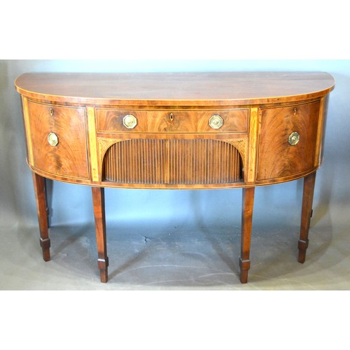 526 - A Regency Mahogany Demi-Lune Sideboard, the line inlaid top above a central drawer and tambour flank... 