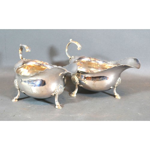 208 - A Pair of George III Silver Sauce Jugs with shaped scroll handles and hoof supports, London 1761, ma... 