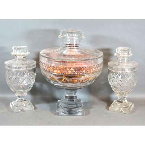 55 - A Garniture of Three 19th Century Glass Covered Vases with square pedestal bases, 33 cms and 26 cms ... 