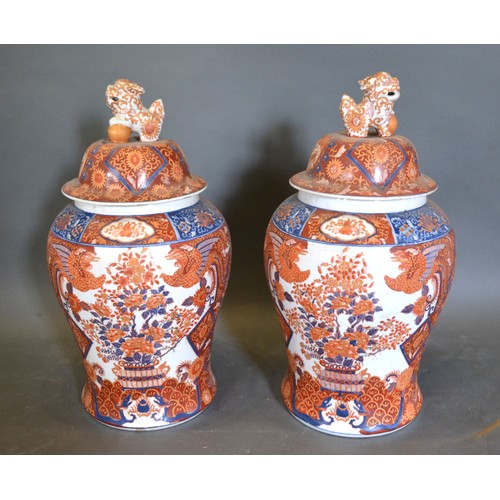 64 - A Pair of Chinese Covered Vases decorated in iron red 49cm tall