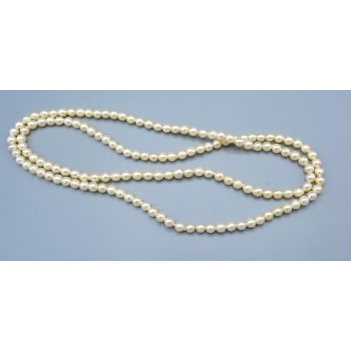 150 - A String of Cultured Pearls together with a Mikimoto case