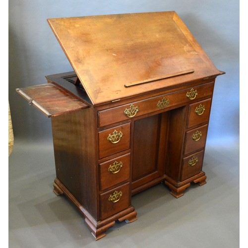 395 - A George III Mahogany Architect's Desk, the hinged top flanked by slides above seven drawers with br... 