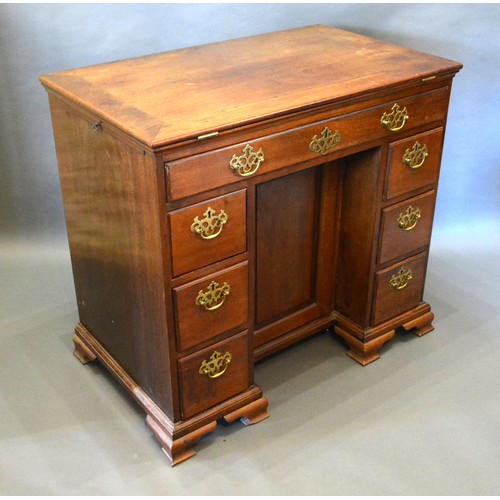 395 - A George III Mahogany Architect's Desk, the hinged top flanked by slides above seven drawers with br... 