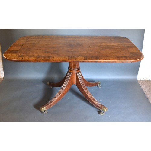 420 - A Regency Mahogany Breakfast Table, the line inlaid and crossbanded top above a reeded centre column... 