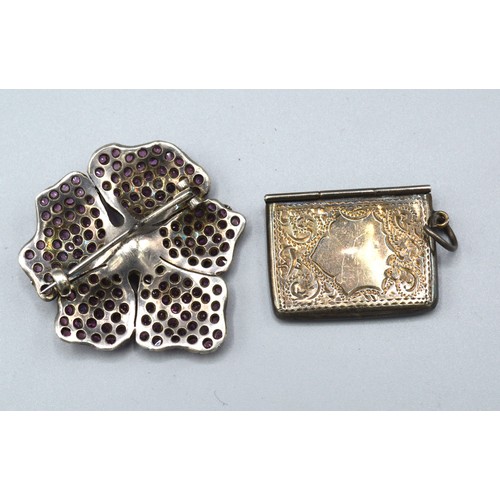 153 - A White Metal Brooch in the form of a flower head encrusted with pink stones with central pearl toge... 