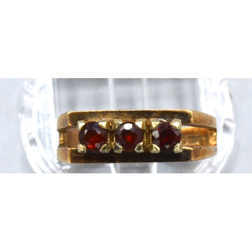 166 - A 9ct Yellow Gold Dress Ring set with three garnets within a pierced setting, 3.3 gms Size K