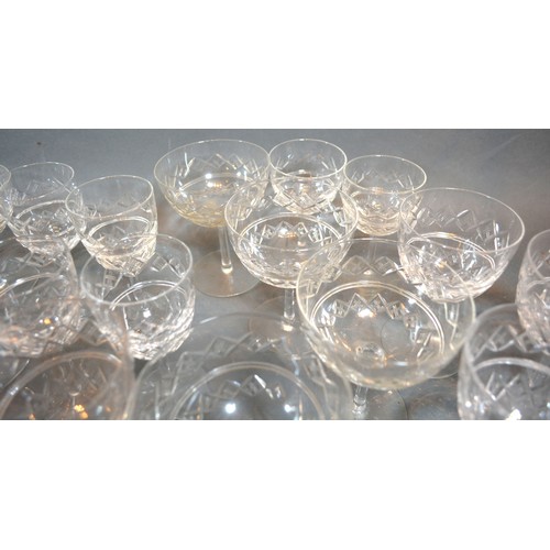 26 - A Large Cut Glass Drinking Set by Webb to include champagne glasses, wine tumblers and bowls