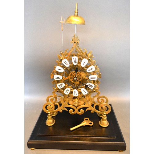 351 - A 20th Century Brass Skeleton Clock of Gothic form with ceramic tablet Roman numerals and with singl... 