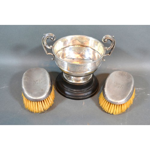 106 - An Edwardian silver two handled trophy cup, Chester 1910, 5oz together with a pair of silver backed ... 