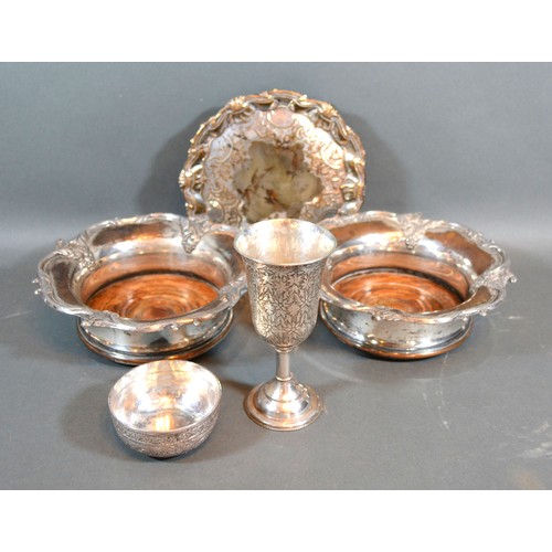 108 - An Indian white metal goblet together with a similar bowl, a pair of silver plated bottle coasters a... 