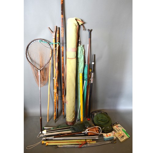 246 - A large collection of fishing accessories to include landing nets, tackle, rests and related items