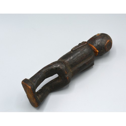 269 - An early African carved figure, 20cms long