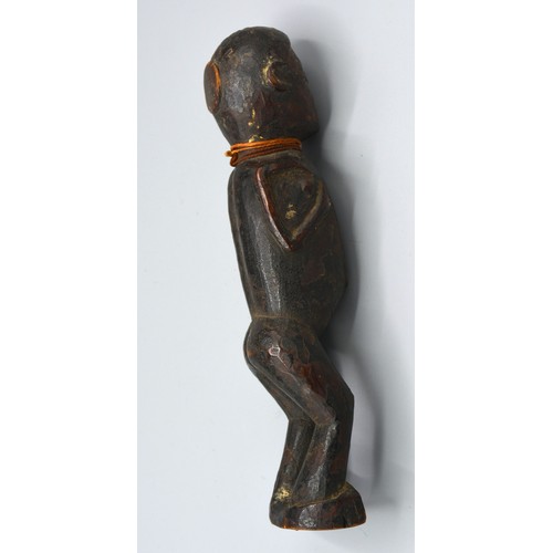 269 - An early African carved figure, 20cms long