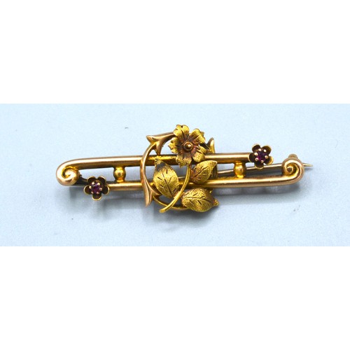 166 - A 15ct Gold Bar Brooch of Foliate Form set with two small garnets