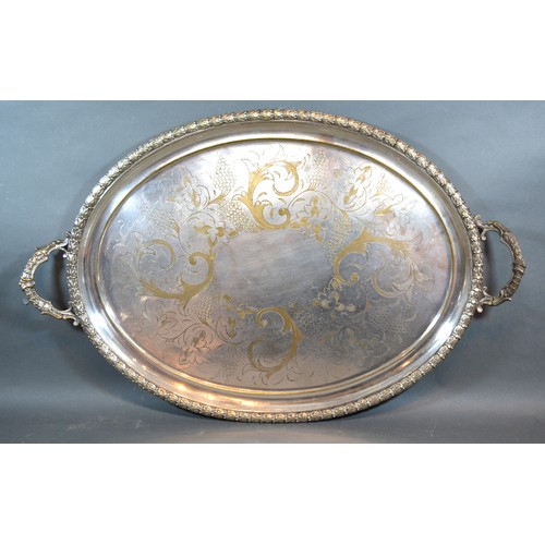 168 - A Large Oval Silver Plated Two Handled Tray with engraved decoration, 47 x 72 cms