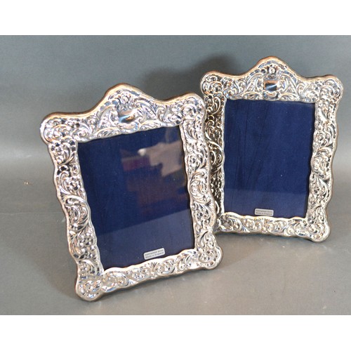 172 - A Pair of 925 Silver Photograph Frames of embossed shaped form, 19.5 x 14.5 cms