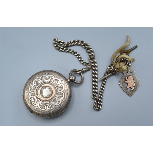 118 - A Chester silver cased pocket watch, the engraved dial with gold mounts and with silver cur link war... 