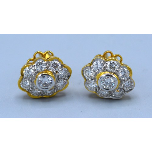 123 - A pair of yellow gold diamond cluster ear studs, each with a central diamond surrounded by diamond w... 