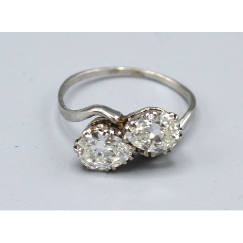 125 - A white gold diamond set crossover ring, set with two diamonds within a pierced setting, approximate... 