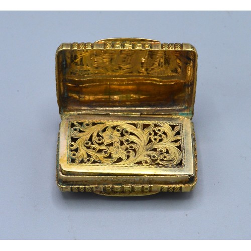 133 - A Georgian silver gilt vinaigrette, the engraved hinged cover enclosing a pierced grill, Birmingham ... 