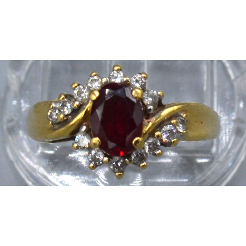 134 - An 18ct gold ring set with an oval ruby surrounded by diamonds, claw set, ring size P, 3.1g