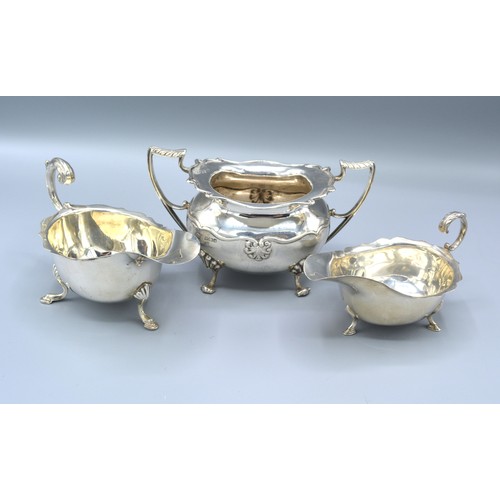 176A - A Birmingham silver two handled sucrier together with two Birmingham silver sauce jugs, 11oz