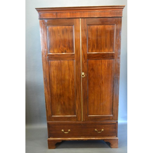 429 - A late 19th century mahogany hall cupboard, the moulded cornice above two doors above drawer raised ... 