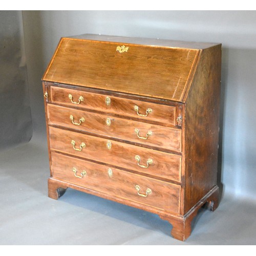 441 - A 19th century mahogany satinwood inlaid bureau, the fall front above four long drawers raised upon ... 