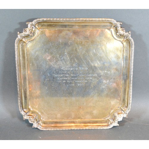 198 - A Birmingham Silver Presentation Salver of shaped outline with four scroll feet and with central ins... 
