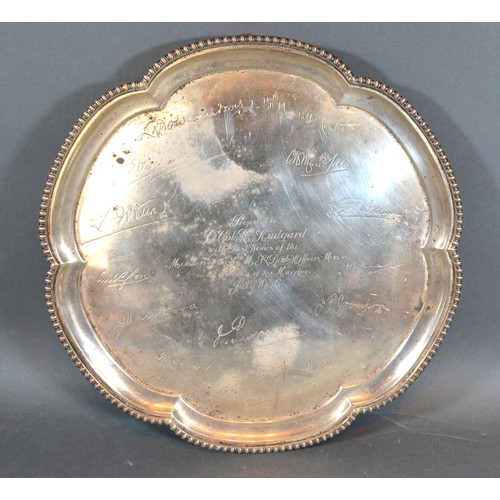 199 - A Sheffield Silver Presentation Salver of shaped outline with three ball and claw feet, 28 ozs. 31.5... 