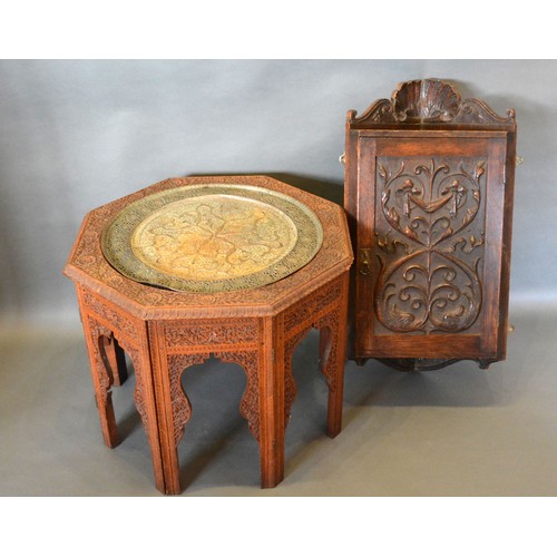 369 - An Indian carved hardwood folding table with pierced brass tray together with a Victorian carved oak... 